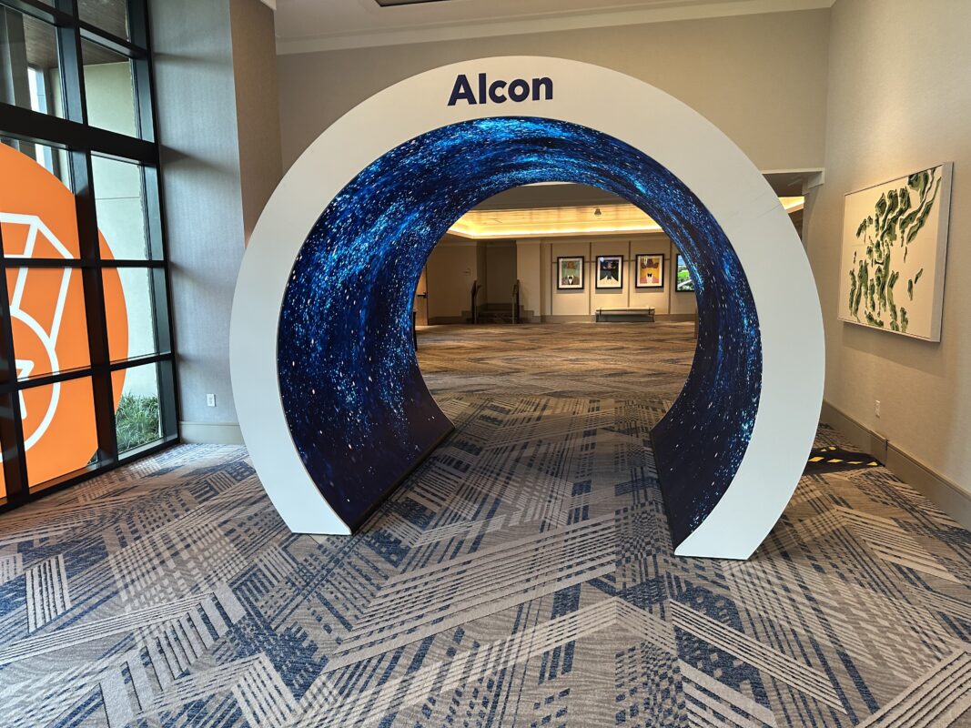 Alcon circular exhibit entrance lined with blue illuminated display panels
