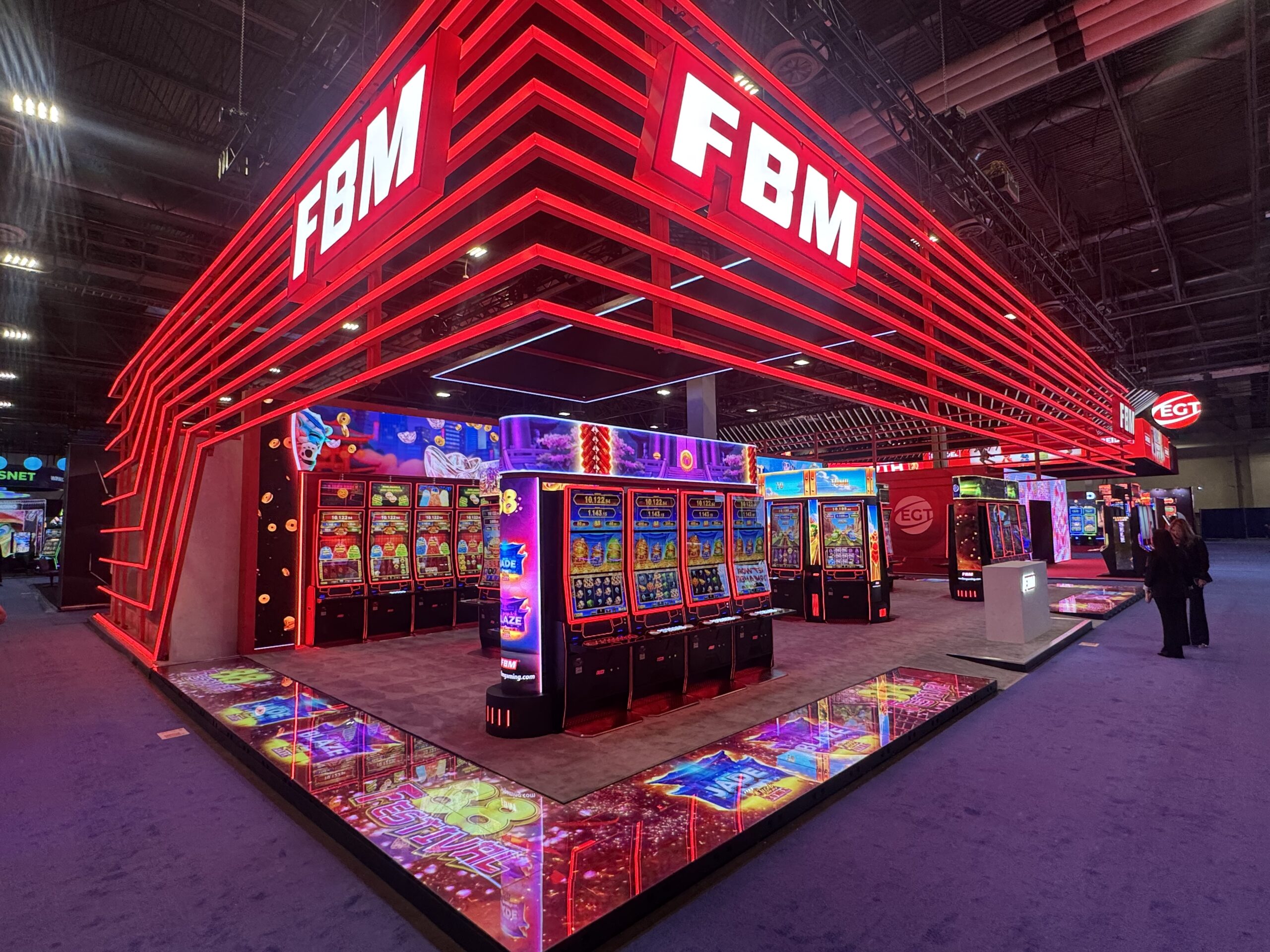 Trade show booth with colorful illuminated floor panels around the perimeter.